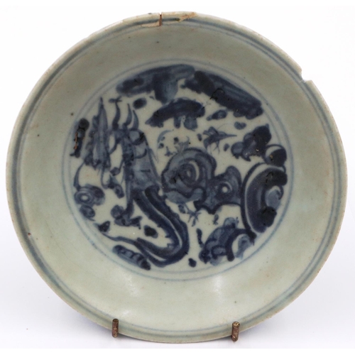 3024 - A Ming Dynasty glazed shallow bowl, with a painted circular panel depicting a dragon amongst clouds,... 