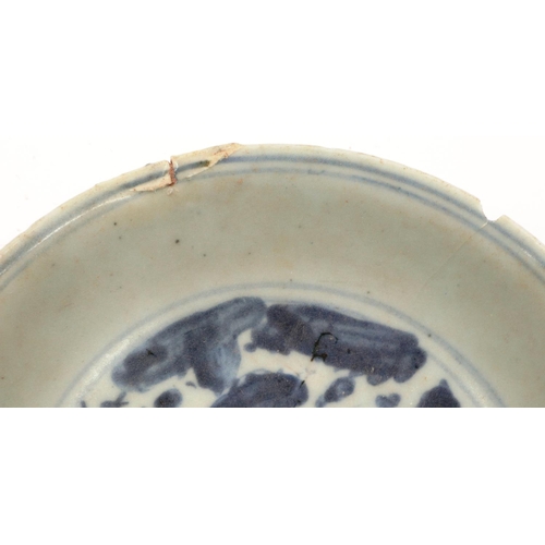 3024 - A Ming Dynasty glazed shallow bowl, with a painted circular panel depicting a dragon amongst clouds,... 