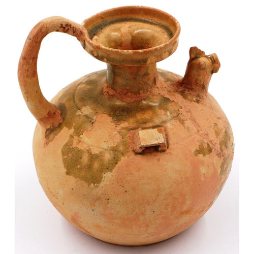 3025 - A celadon bulbous ewer, having a rooster form spout, lipped rim and still retaining some of its glaz... 