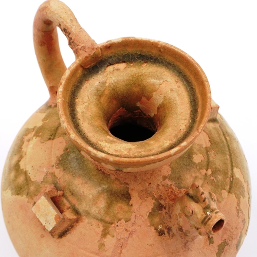 3025 - A celadon bulbous ewer, having a rooster form spout, lipped rim and still retaining some of its glaz... 