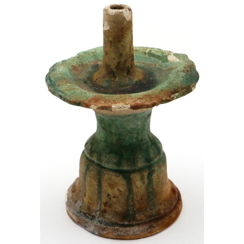 3030 - A Ming Dynasty glazed white clay taper stand, having a pricket with drip tray supported on a bell fo... 