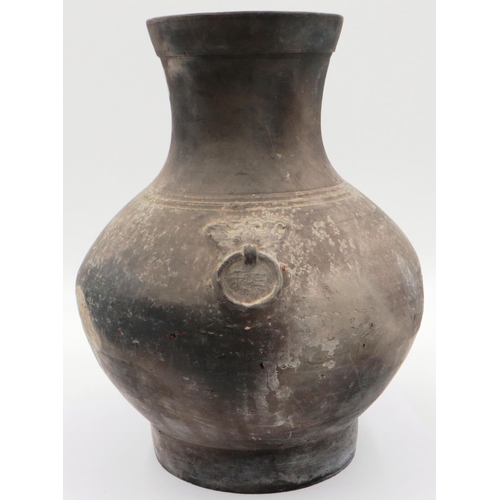 3032 - An early Qing Dynasty grey clay jar, baluster form with integral faux ring handles, footed base and ... 