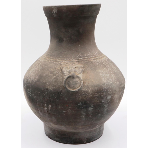 3032 - An early Qing Dynasty grey clay jar, baluster form with integral faux ring handles, footed base and ... 