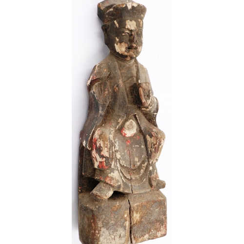 3035 - A Ming Dynasty carved wood figure of a seated official with cup, still retaining some of its origina... 