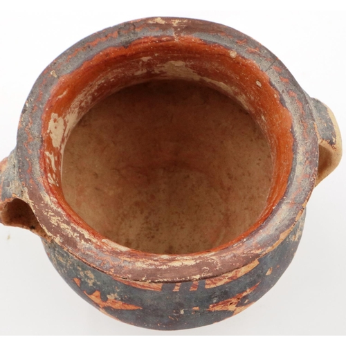 3047 - A Neolithic period painted terracotta twin handled pot, decorated with geometric designs, H: 8 cm, D... 