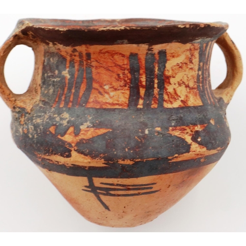 3047 - A Neolithic period painted terracotta twin handled pot, decorated with geometric designs, H: 8 cm, D... 