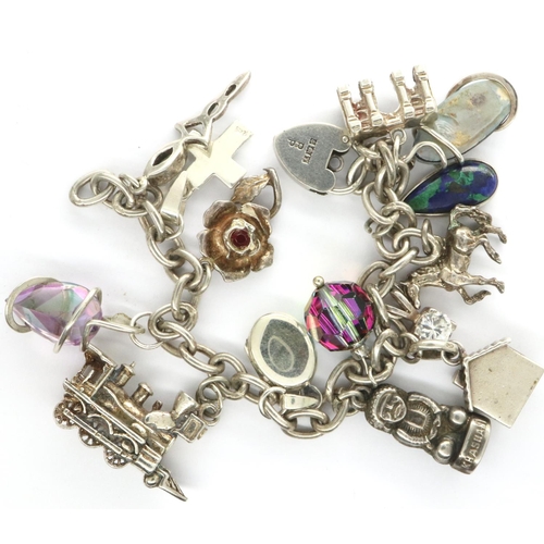 14 - 925 silver charm bracelet with fourteen charms to include a horse, L: 20 cm. P&P Group 1 (£14+VAT fo... 