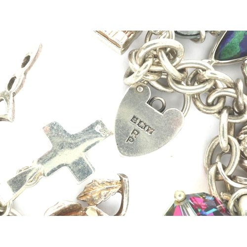 14 - 925 silver charm bracelet with fourteen charms to include a horse, L: 20 cm. P&P Group 1 (£14+VAT fo... 