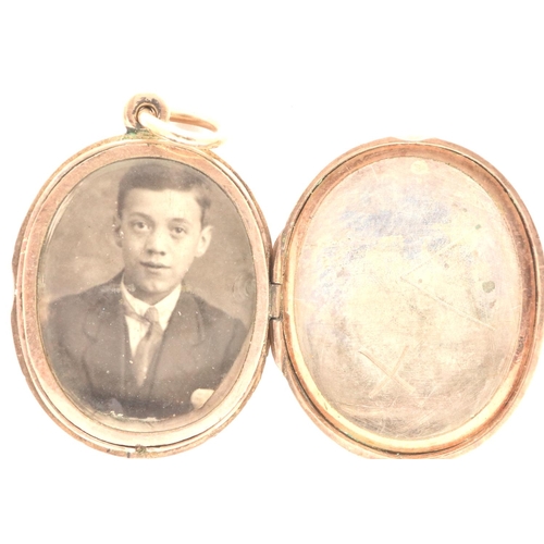 57 - Presumed (unmarked) 9ct gold locket with floral chased detail, with jump ring, lacking one glass, 5.... 