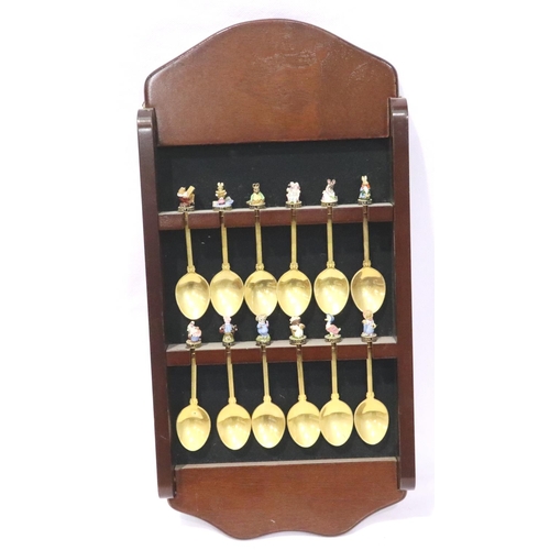 386 - A set of twelve gold plated teaspoons, each finial cast and enamelled with a Beatrix Potter characte... 