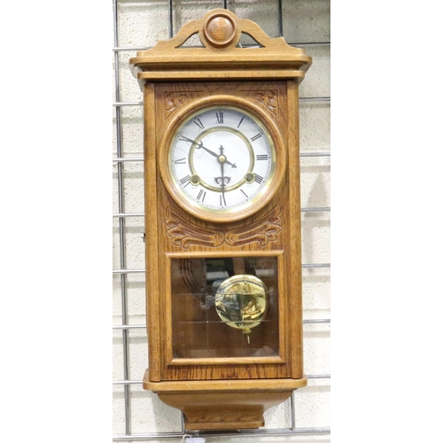 412 - A 20th century oak cased wall clock, chiming on a gong with glazed display door, H: 53 cm, working a... 