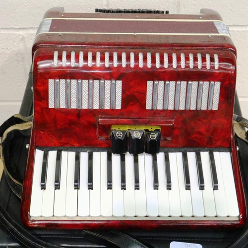 409 - Italian junior accordion in working order with case, not named. Some splits to plastic and discolour... 