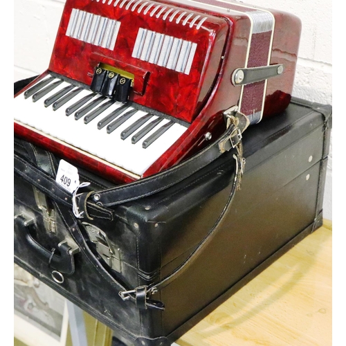 409 - Italian junior accordion in working order with case, not named. Some splits to plastic and discolour... 