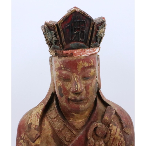 3049 - A large and rare Ming Dynasty gilt wood seated figure of a court official, raised on a lotus-leaf ba... 