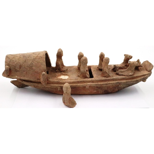 3052 - A rare Eastern Han Dynasty pottery boat, having six seated figures (one detached but present) and tw... 