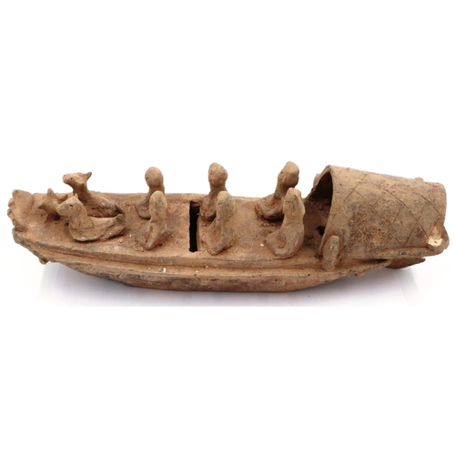 3052 - A rare Eastern Han Dynasty pottery boat, having six seated figures (one detached but present) and tw... 