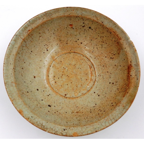 3056 - A Song Dynasty glazed bowl, near celadon in colour, D: 16 cm, H: 6 cm. Some chips to the rim and min... 