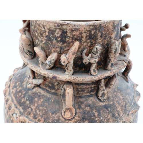 3058 - A Tang Dynasty funerary urn, having applied figures and beasts to the neck, H: 28 cm. Loss to the ba... 