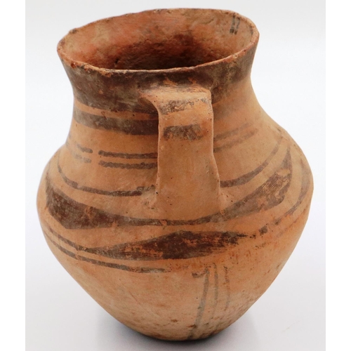 3064 - A Chinese Neolithic period urn, retaining most of its polychrome decoration and having two handles, ... 