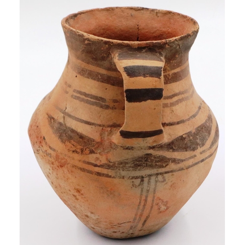 3064 - A Chinese Neolithic period urn, retaining most of its polychrome decoration and having two handles, ... 