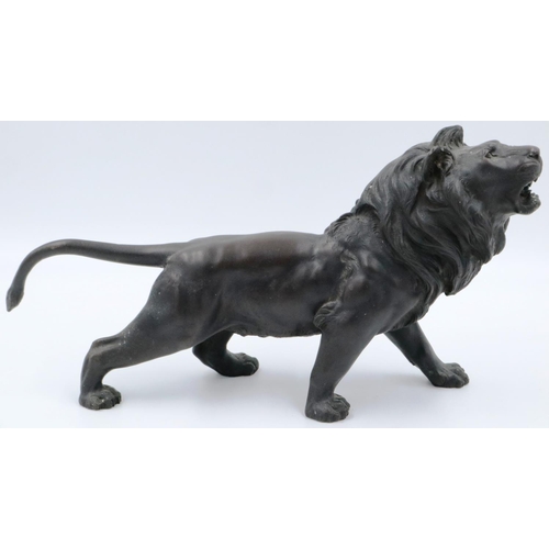 3066 - A Japanese Meiji period cast bronze figure of a lion, with impressed seal mark to its belly, L: 45 c... 