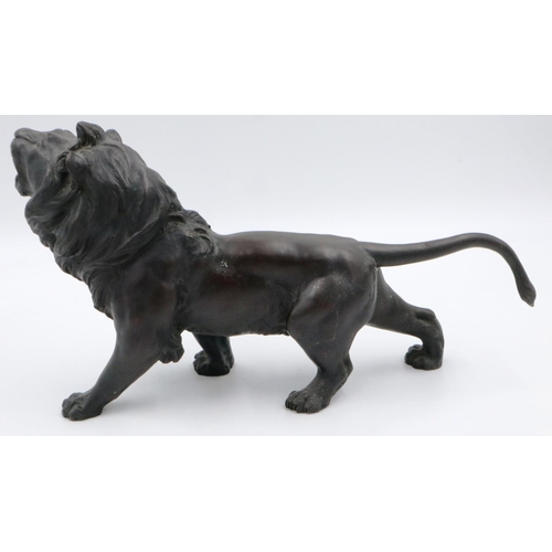 3066 - A Japanese Meiji period cast bronze figure of a lion, with impressed seal mark to its belly, L: 45 c... 