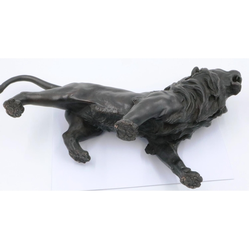 3066 - A Japanese Meiji period cast bronze figure of a lion, with impressed seal mark to its belly, L: 45 c... 