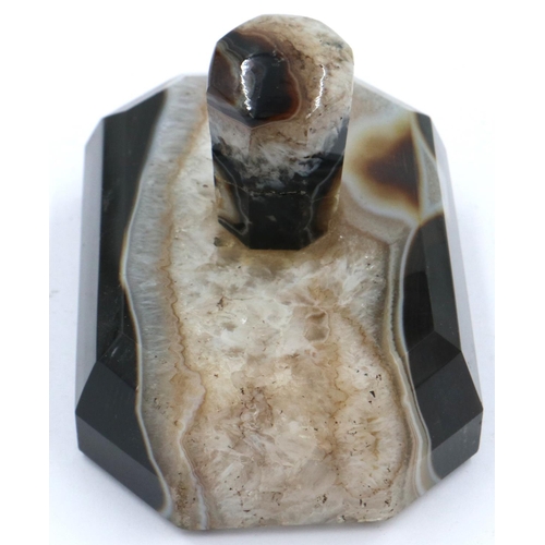 3081 - A banded and laced brown manao agate paperweight, being a tapering block surmounted with an octagona... 