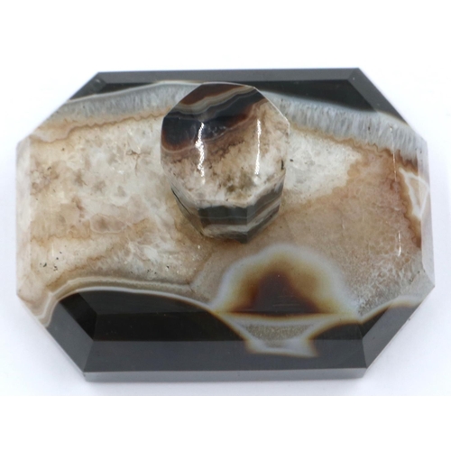 3081 - A banded and laced brown manao agate paperweight, being a tapering block surmounted with an octagona... 