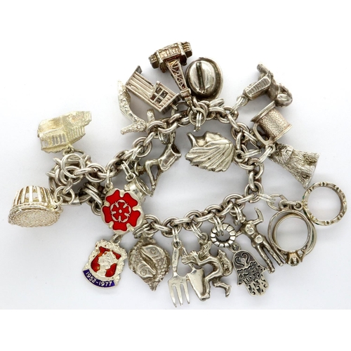 25 - 925 silver charm bracelet with twenty charms, L: 18 cm, combined 67g. P&P Group 1 (£14+VAT for the f... 