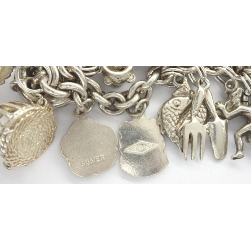 25 - 925 silver charm bracelet with twenty charms, L: 18 cm, combined 67g. P&P Group 1 (£14+VAT for the f... 