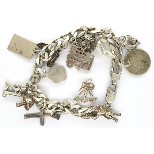 41 - 925 silver charm bracelet with thirteen charms, L: 20 cm, combined 45g. P&P Group 1 (£14+VAT for the... 