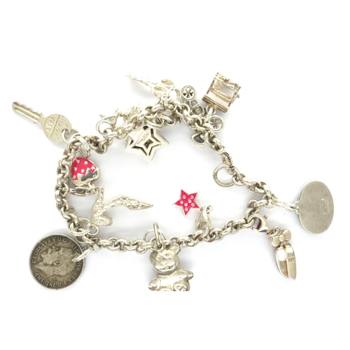 43 - 925 silver charm bracelet with twelve charms, L: 17 cm, combined 28g. P&P Group 1 (£14+VAT for the f... 