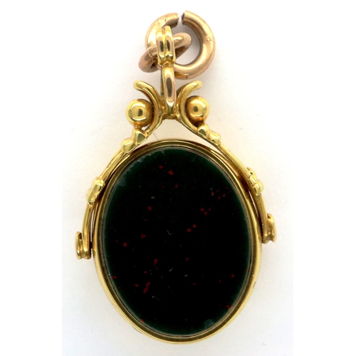 22 - 9ct gold spinning fob set with bloodstone and carnelian, 8.2g. P&P Group 1 (£14+VAT for the first lo... 