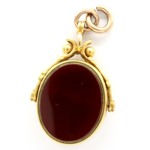 22 - 9ct gold spinning fob set with bloodstone and carnelian, 8.2g. P&P Group 1 (£14+VAT for the first lo... 