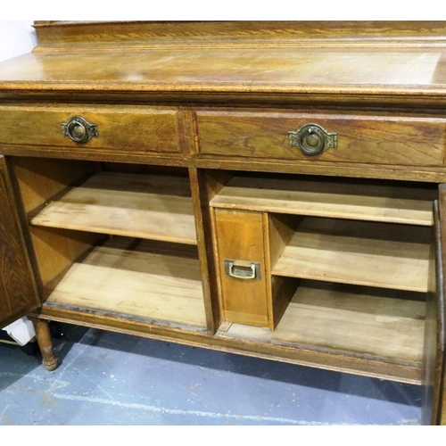 3094 - An Arts and Crafts period oak dresser with mirrored back, cupboard base and three bottle cellarette ... 