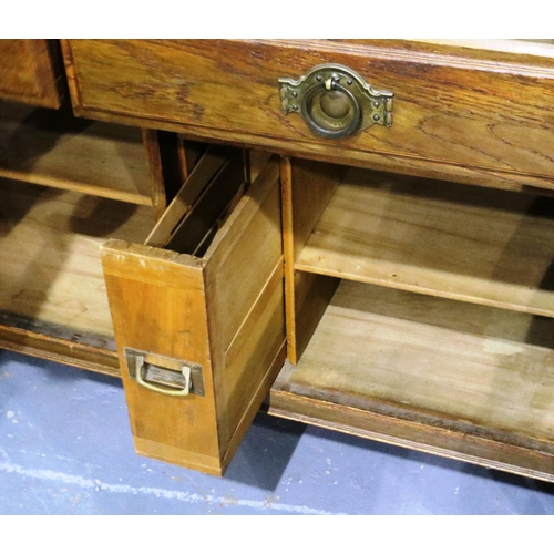 3094 - An Arts and Crafts period oak dresser with mirrored back, cupboard base and three bottle cellarette ... 