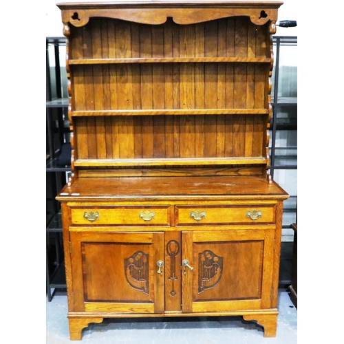 3095 - Art Nouveau cross banded dresser with two cupboards and two drawers with carved decoration by W.E Gr... 