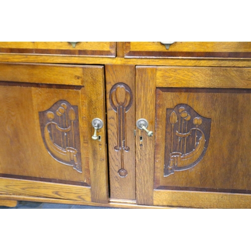 3095 - Art Nouveau cross banded dresser with two cupboards and two drawers with carved decoration by W.E Gr... 