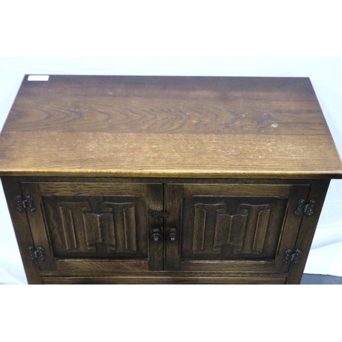 3099 - Oak two door cupboard with drawer below with linenfold decoration, 79 x 41 x 85 cm H. Not available ... 