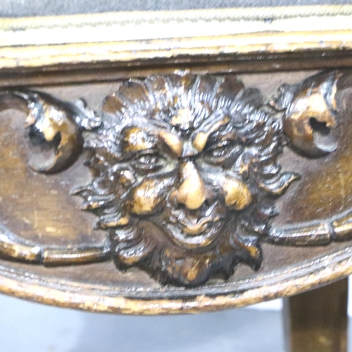 3101 - A 19th century mahogany hall chair, the backrest heavily carved with figureheads and broken pediment... 