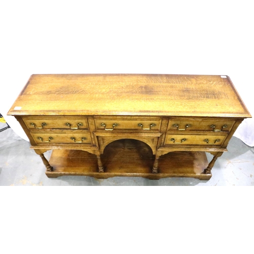 3102 - Cross banded oak sideboard with five drawers with turn supports rising from a solid base and swan ne... 