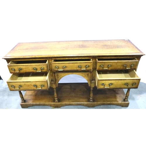 3102 - Cross banded oak sideboard with five drawers with turn supports rising from a solid base and swan ne... 