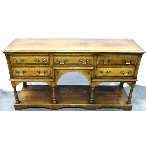 3102 - Cross banded oak sideboard with five drawers with turn supports rising from a solid base and swan ne... 