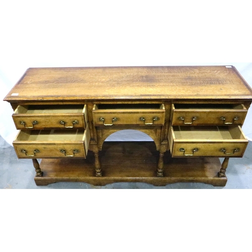 3102 - Cross banded oak sideboard with five drawers with turn supports rising from a solid base and swan ne... 