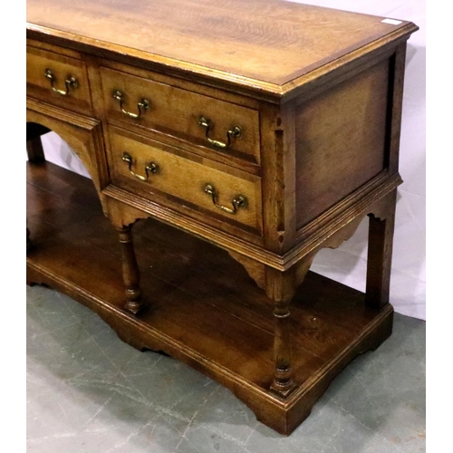 3102 - Cross banded oak sideboard with five drawers with turn supports rising from a solid base and swan ne... 