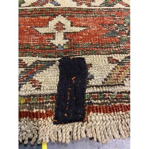 3071 - Large woollen runner, 95 x 455 cm. fading to array tassels are missing on one end, small tears to ed... 