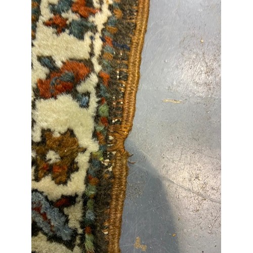 3071 - Large woollen runner, 95 x 455 cm. fading to array tassels are missing on one end, small tears to ed... 