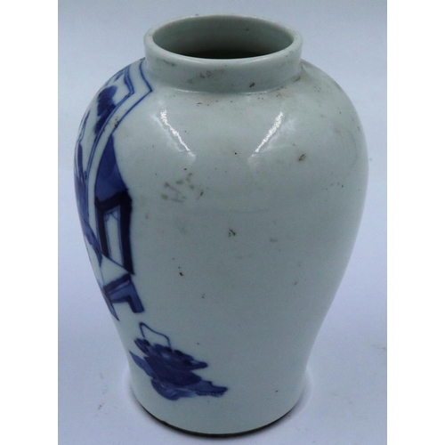 3299 - A Kangxi glazed baluster form jar of diminutive proportions, simply decorated in blue of two seated ... 