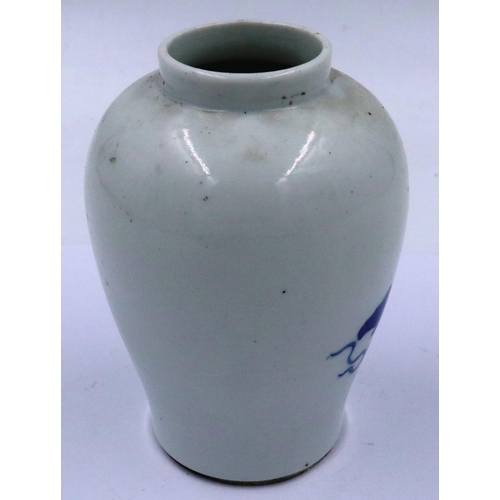 3299 - A Kangxi glazed baluster form jar of diminutive proportions, simply decorated in blue of two seated ... 